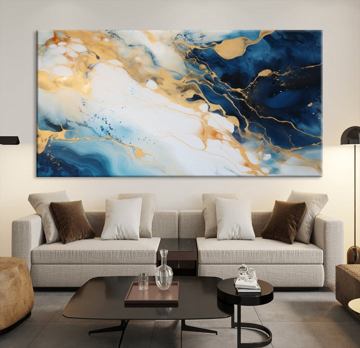 A modern living room featuring museum-quality Blue Gold Abstract Wall Art Print Contemporary art in a triptych arrangement.