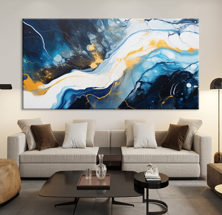 The Navy Blue Abstract Wall Art Canvas Print, displaying an exquisite array of blue, white, and gold swirls, is crafted on museum-quality canvas and enhances the space with its sophisticated elegance.