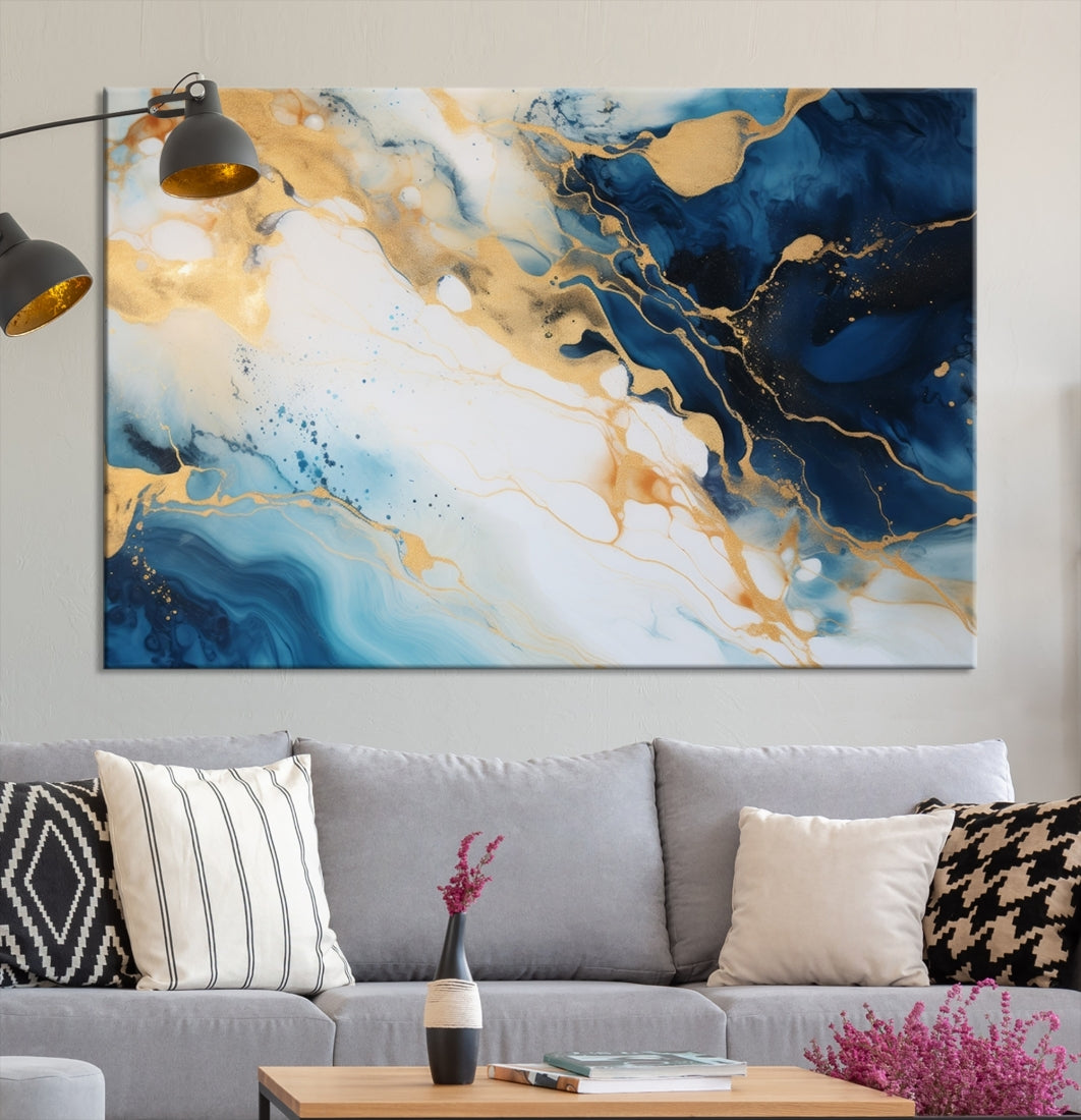 A modern living room featuring museum-quality Blue Gold Abstract Wall Art Print Contemporary art in a triptych arrangement.