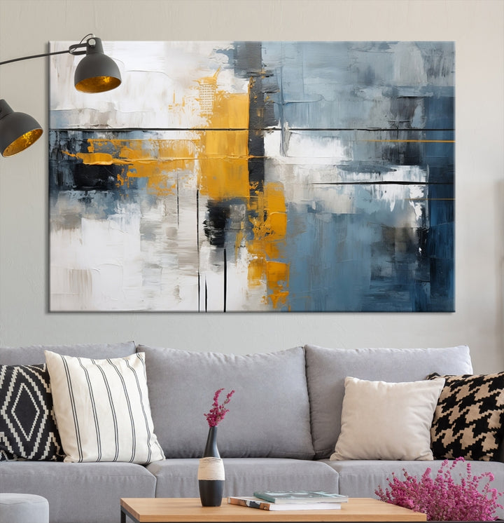 The Orange Abstract Wall Art Print features a series of white, blue, black, and yellow blocks arranged in a triptych format on museum-quality canvases. Proudly made in the USA and offered with free shipping.