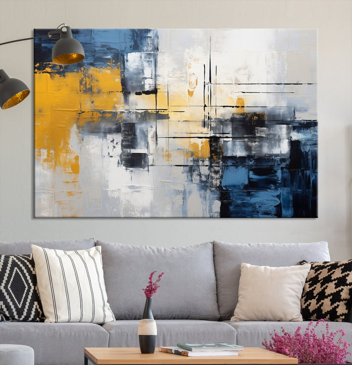 The Yellow Orange Blue Abstract Wall Art Print on gallery-wrapped, museum-quality canvases adds a vibrant touch to the room.