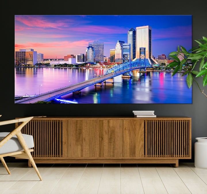 The Jacksonville Wall Art Canvas Print, showcasing the Jacksonville cityscape over a river at sunset, is elegantly crafted on museum-quality canvas with a UV-protective coating. Ready to hang, it elevates your space with its sophisticated charm.