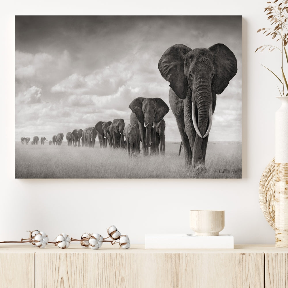 The Elephant Wall Art Canvas Print features a triptych of elephants in a savanna, elegantly displayed.