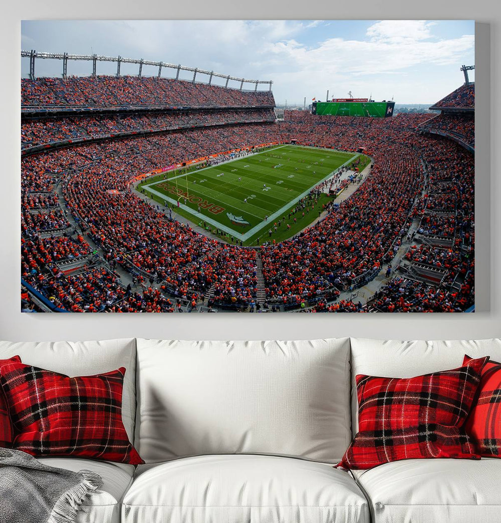 The Denver Broncos Football Print features a vibrant, fan-filled orange stadium overlooking the football field.