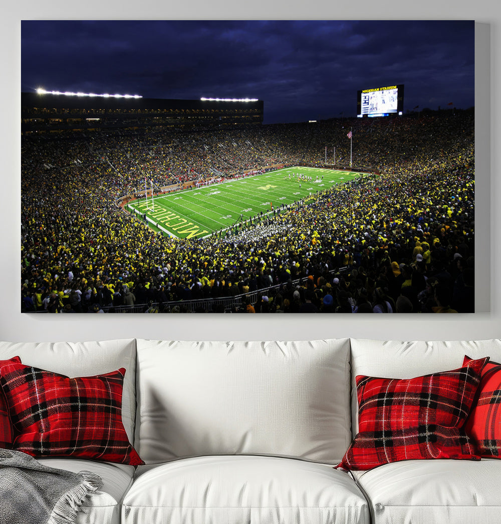 A painting of the packed Michigan Wolverines football stadium at night.