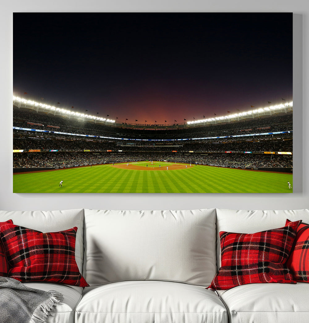 A night game at Yankee Stadium depicted on canvas beneath a sunset sky.