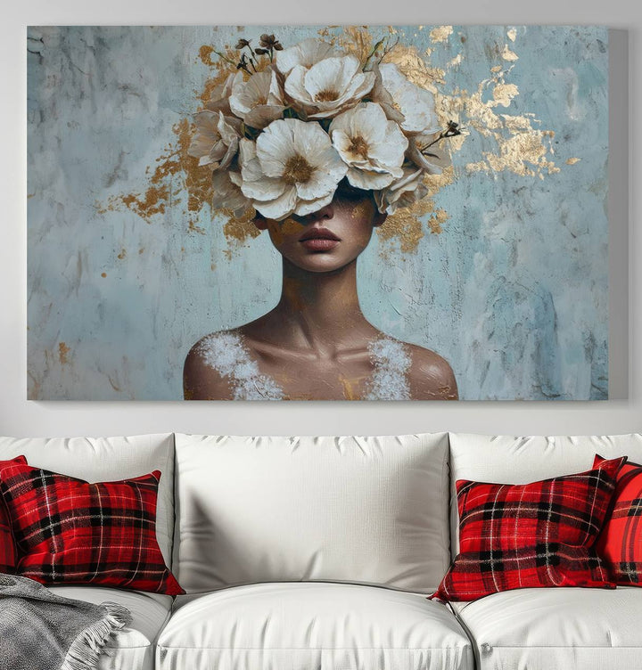 The Golden Petal Silhouette Woman Wall Art Canvas Print, a large 3-panel canvas with a textured gold floral design, serves as a luxurious centerpiece in modern glam settings. The artwork depicts a woman with flowers over her eyes against a textured background and hangs elegantly.