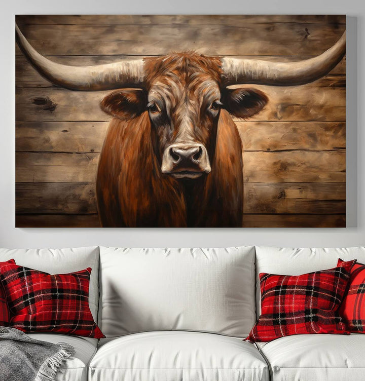 The Longhorn Bull Wall Art, a ready-to-hang canvas print, showcases an image of a brown longhorn cow set against a wooden background, perfect for those looking to enhance their space with rustic farmhouse and western barn decor.