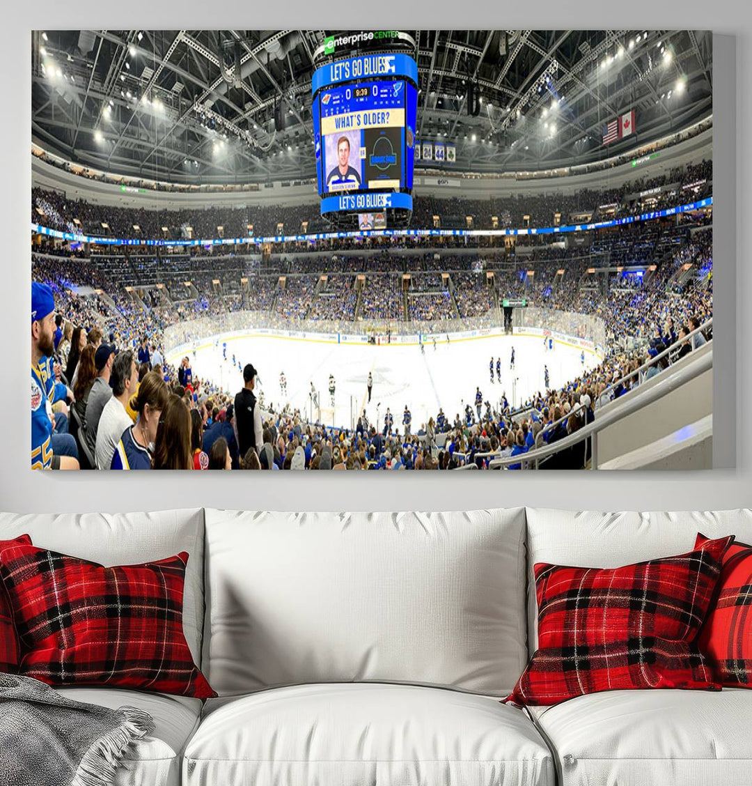 Wall art prints depicting the bustling scenes of the St. Louis Blues being cheered on by a full house at the Enterprise Center, beneath a large scoreboard.