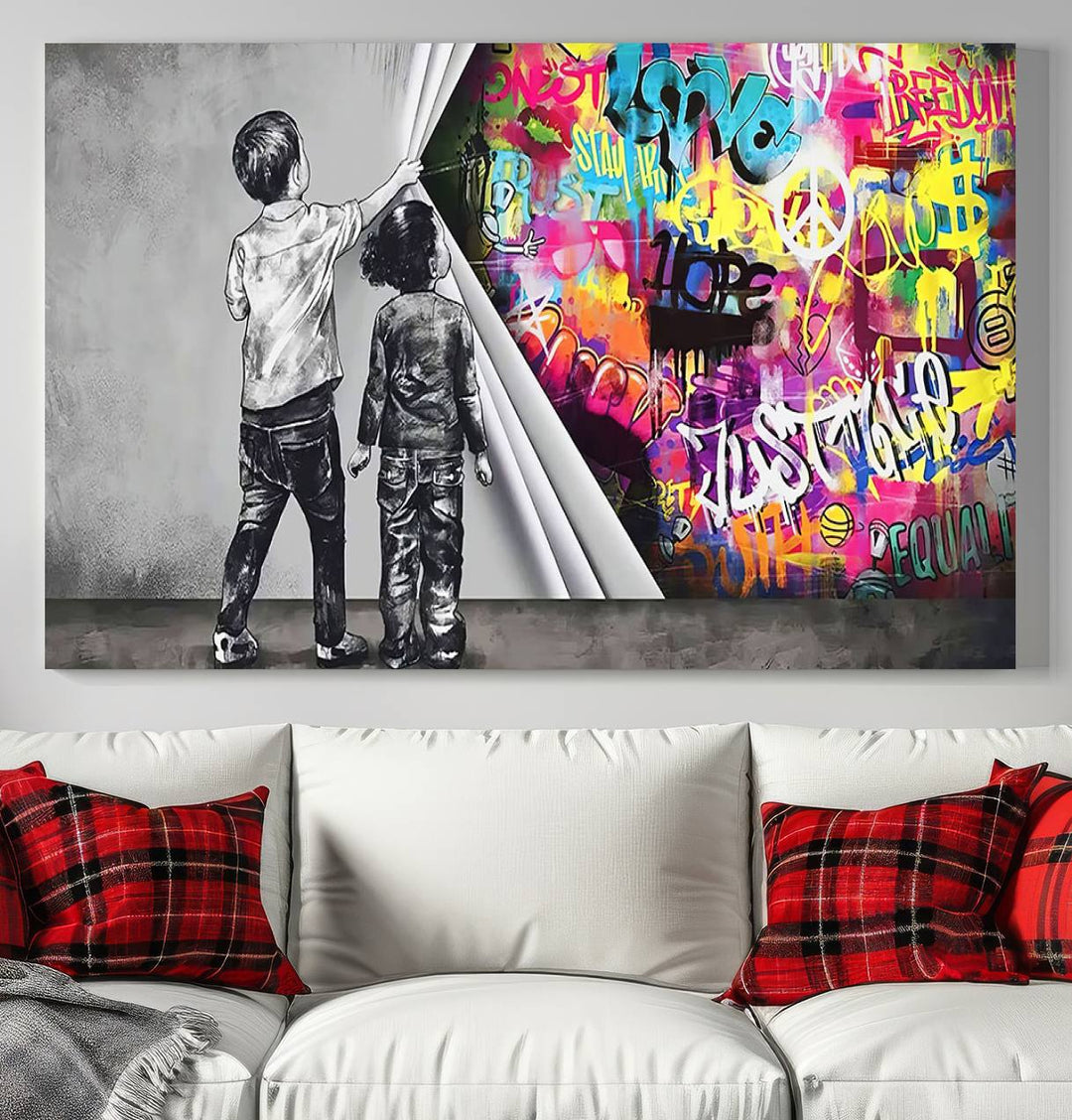 The Banksy Print - Street Art Canvas features a vibrant and bold image of two children lifting a curtain to reveal colorful graffiti. It's ready to hang, adding an urban modern decor vibe.