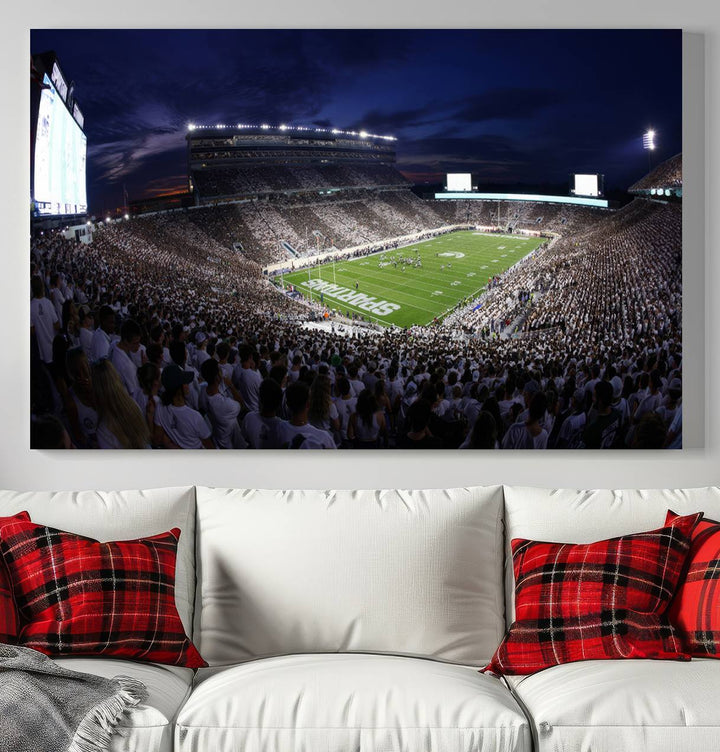 A packed football stadium at night, with bright lights and fans in white, depicted in a Michigan State Spartans Stadium wall art.