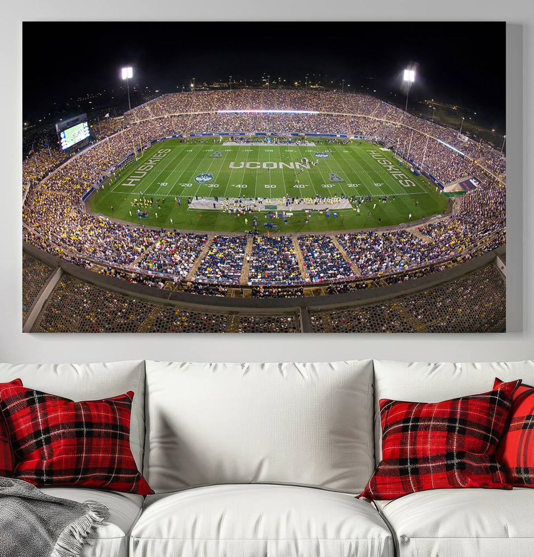 A large football stadium at night, featuring the UCONN Huskies, is depicted on the East Hartford Pratt & Whitney Stadium Wall Art Canvas Print.