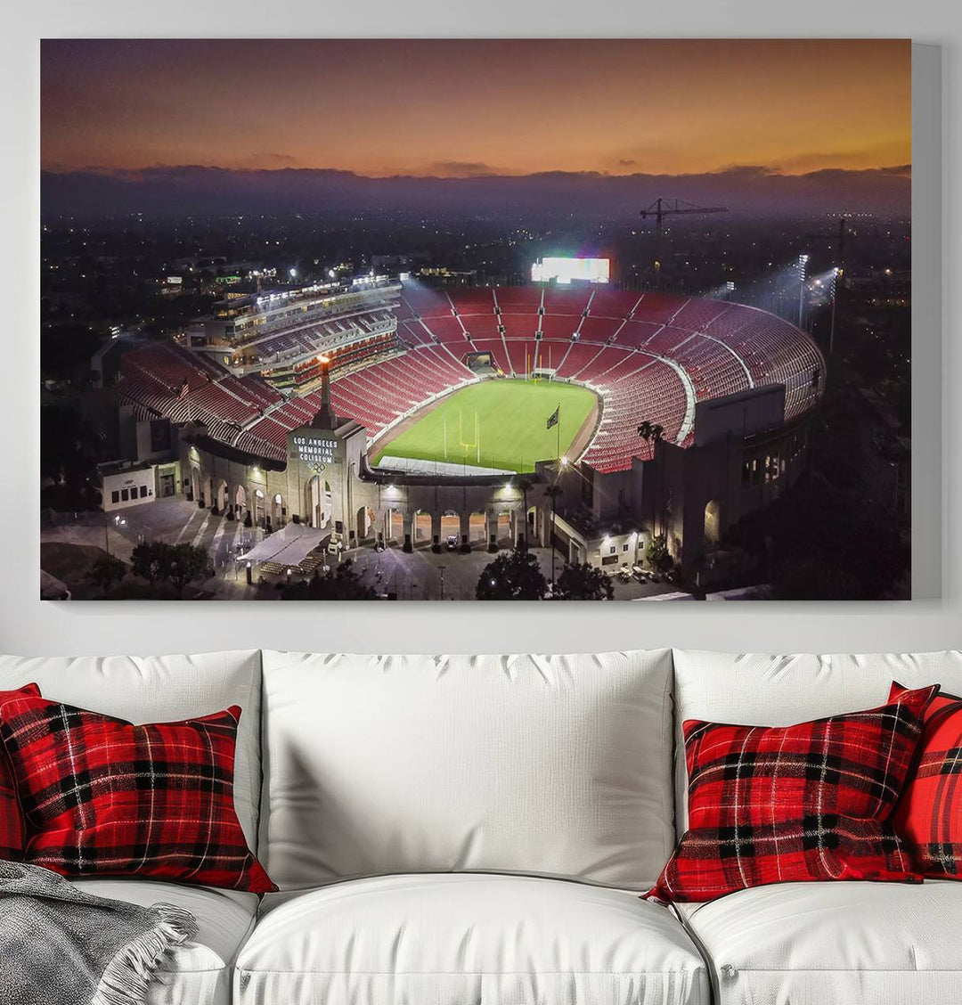 The USC Trojans Stadium canvas captures Memorial Coliseum at twilight, showcasing red seats and a green field beneath an orange sky.