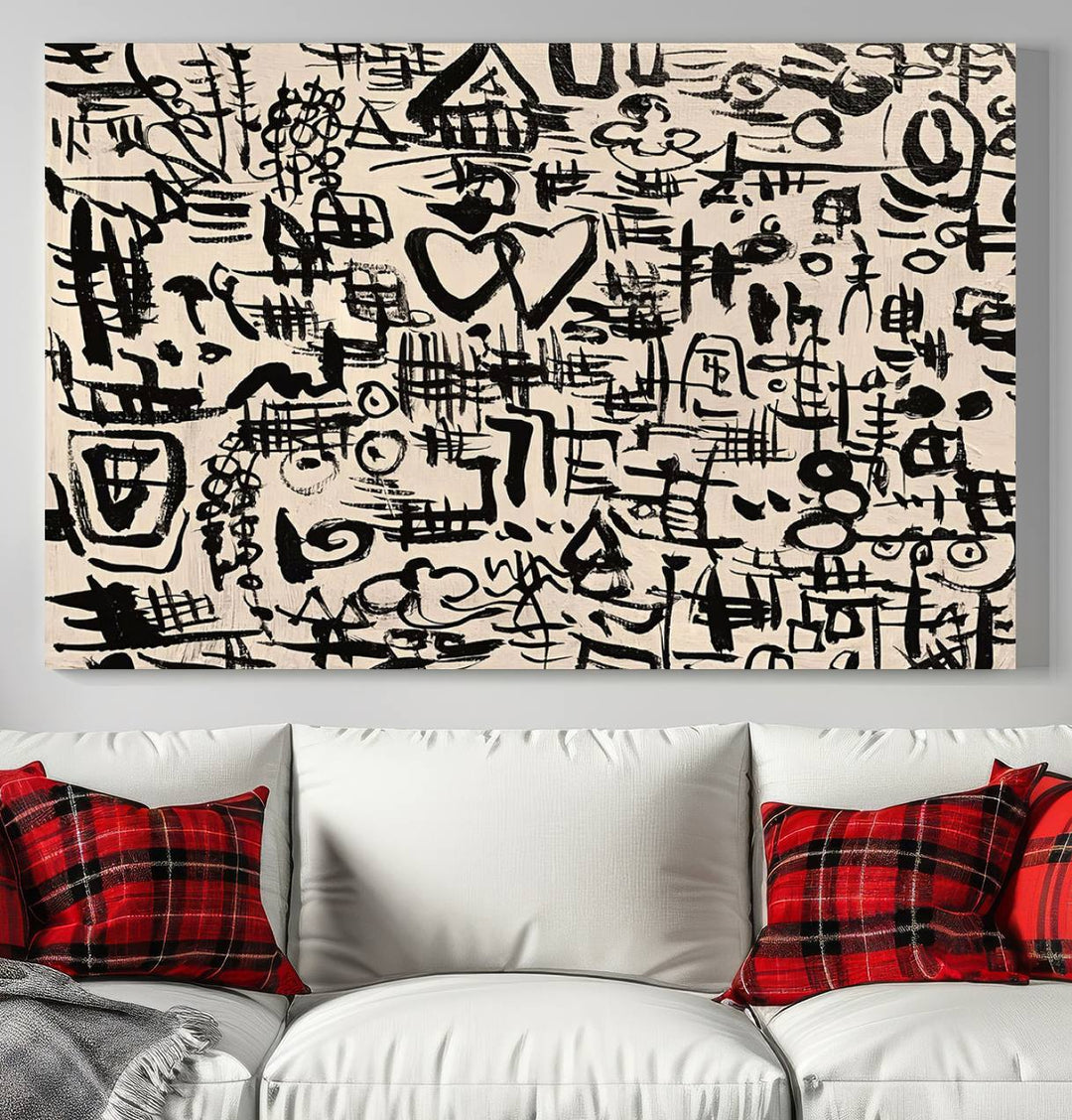 The Abstract Love and Chaos canvas is a museum-quality print featuring black symbols on a beige background, adorned with a heart and scribble design. It is framed to enhance its artistic appeal.