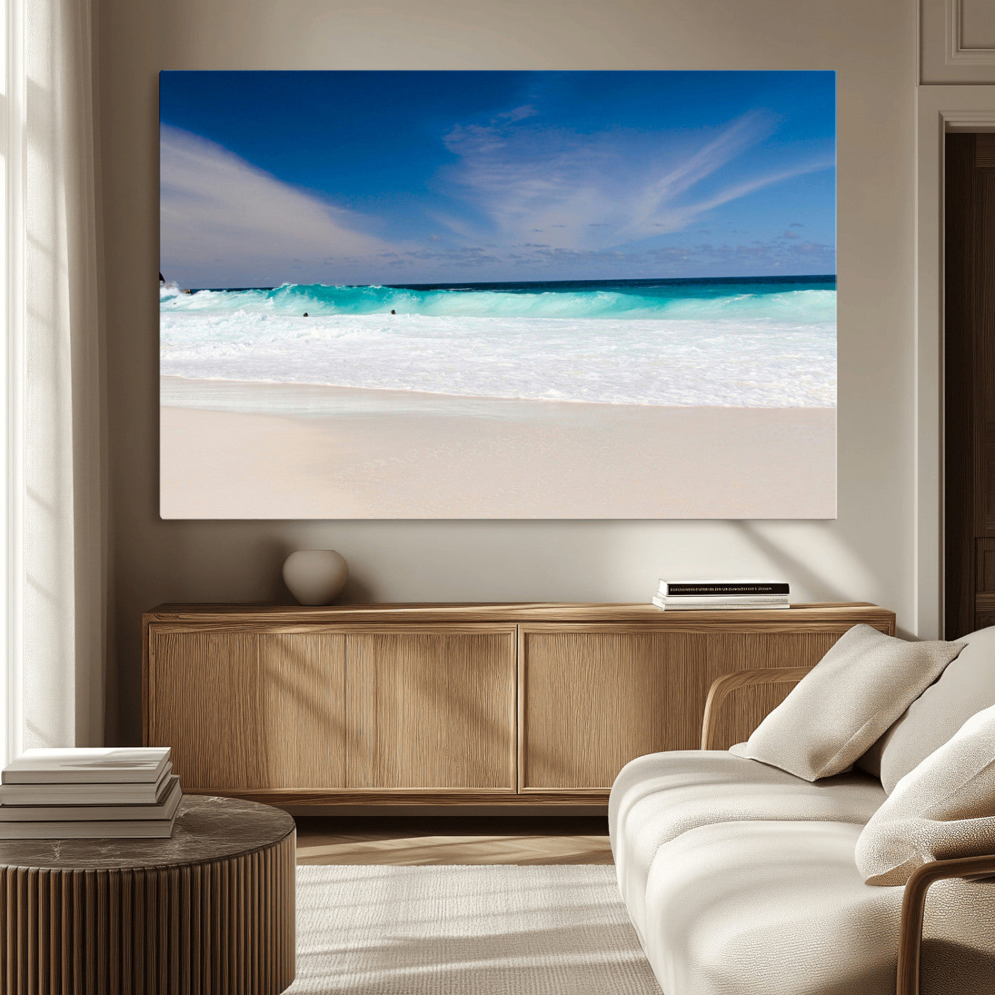Turquoise waves crash onto a pristine white sand beach under a vivid blue sky with wispy clouds, creating a peaceful and refreshing coastal scene.