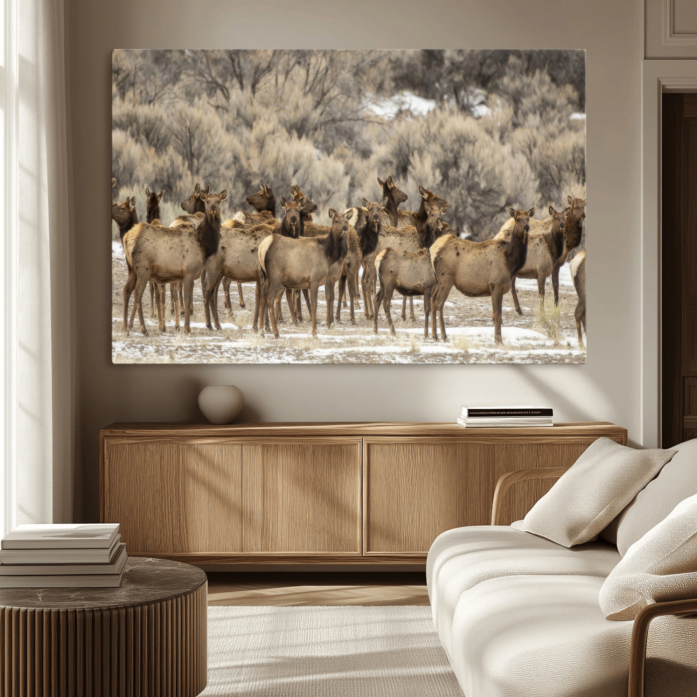 A stunning wall art canvas print featuring a large herd of elk standing together in a natural winter landscape with muted earthy tones and soft background foliage, perfect for rustic or nature-inspired home decor.
