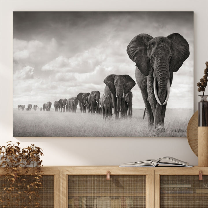 The "Herd of Elephants Wall Art Canvas Print" features an elegant black and white triptych of elephants walking in a line, beautifully displayed on museum-quality canvas with a UV-protective coating. This artwork arrives ready to hang and adds sophistication to any space.