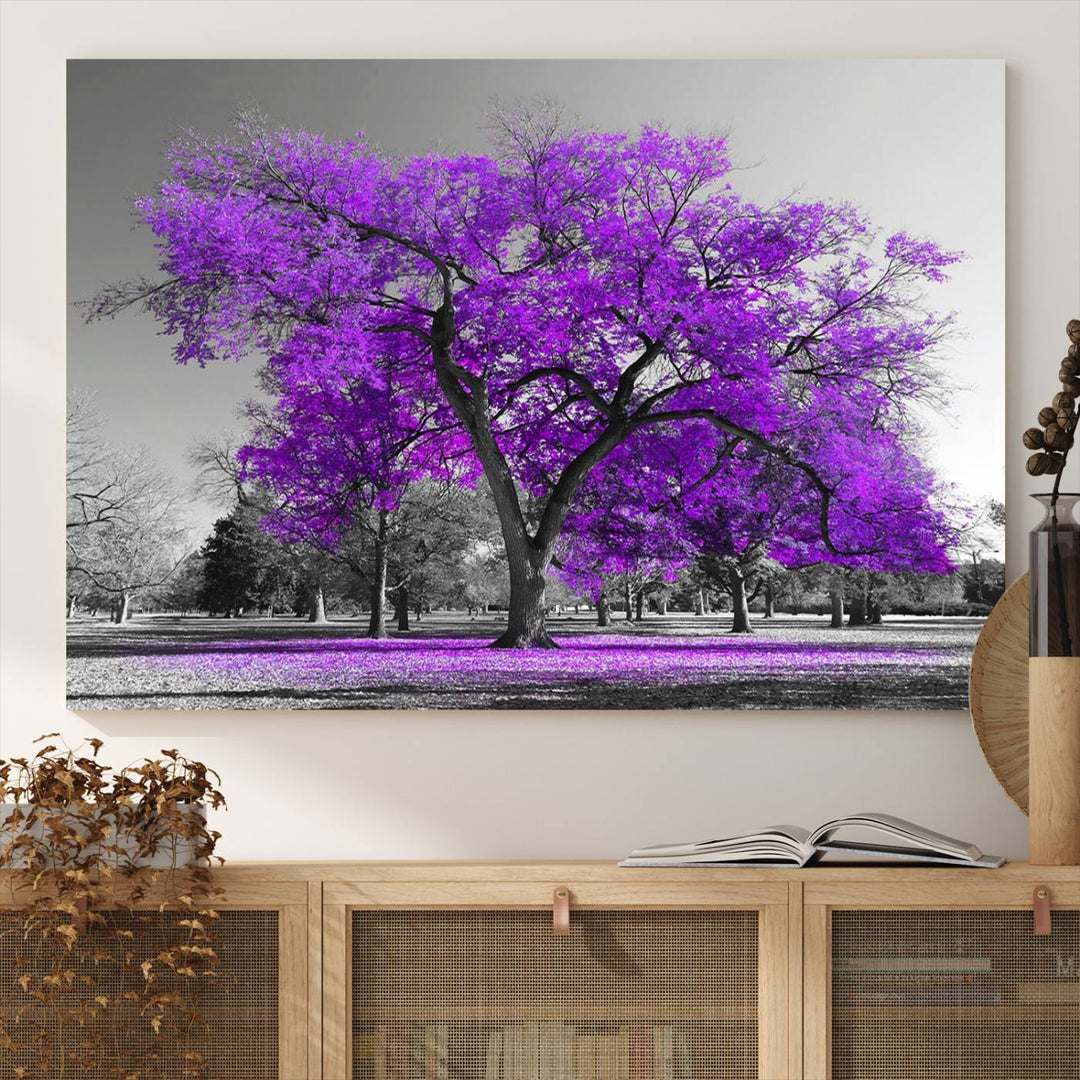 The Big Purple Tree Wall Art Canvas Print showcases a vibrant purple tree set against a black-and-white landscape.