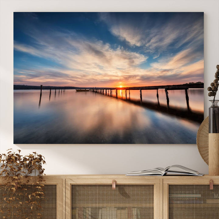 The Sunset Pier Canvas features a serene coastal landscape with vibrant hues under cloudy skies, ideal for modern decor.