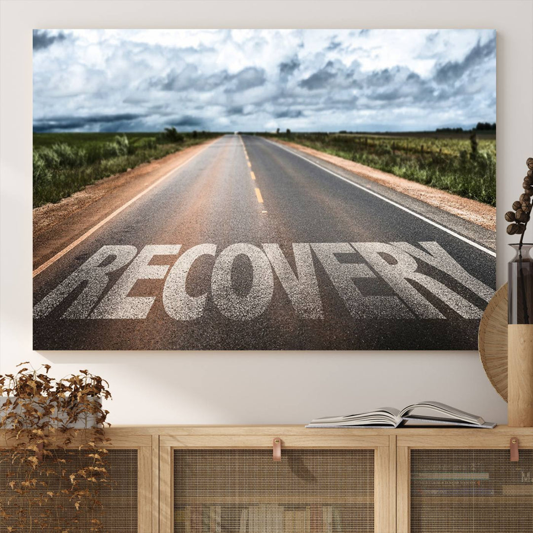 The Recovery Road Wall Art Canvas Print depicts a road under a cloudy horizon.