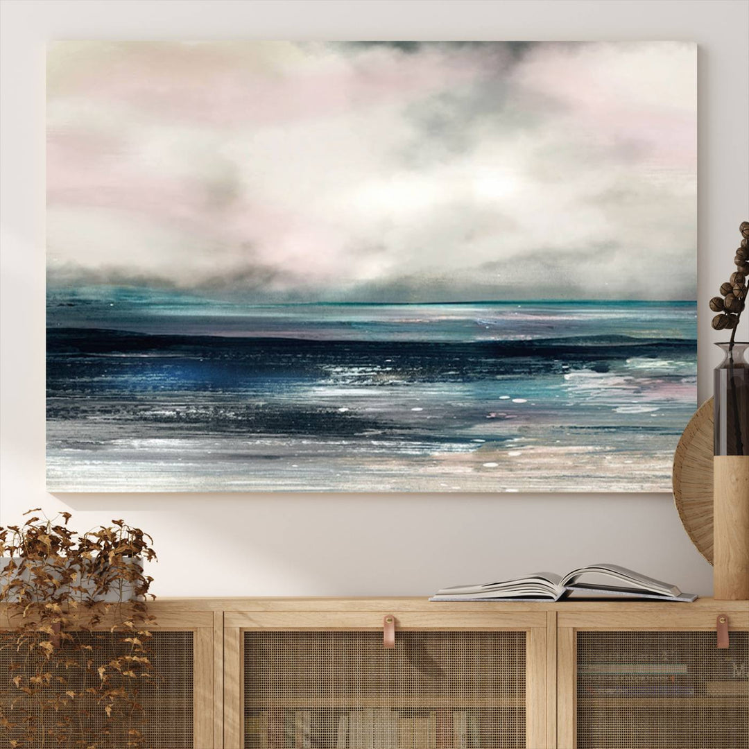 A contemporary abstract wall art canvas print in pastel pink, teal, and gray tones hangs on the wall.