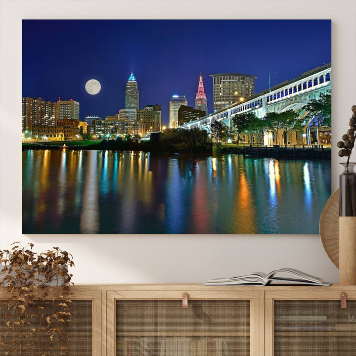 Cleveland City Lights Night Skyline Wall Art canvas showcases a moonlit cityscape reflected on water.