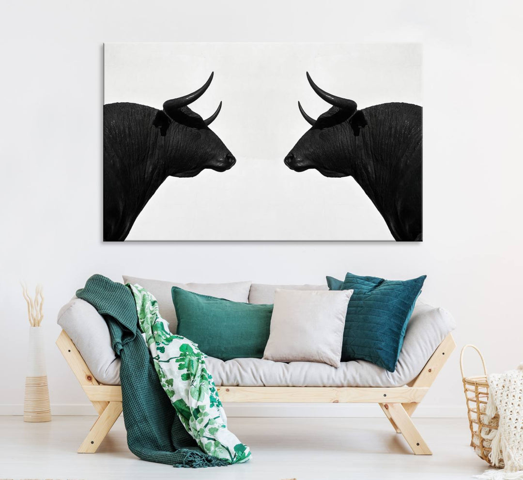 A framed canvas print featuring two black bull silhouettes, perfect for modern rustic decor.