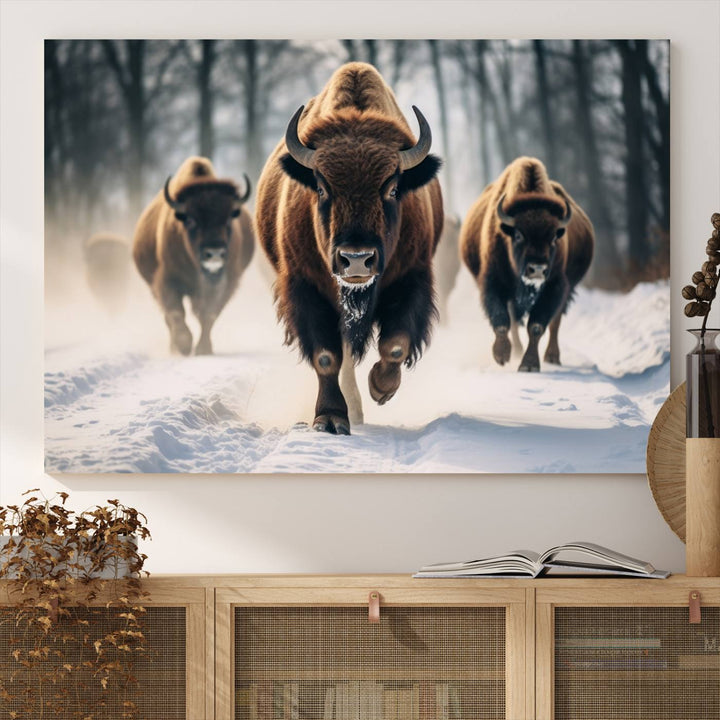 Wall art titled Cow Bighorn shows three bison running through snow in a forest.