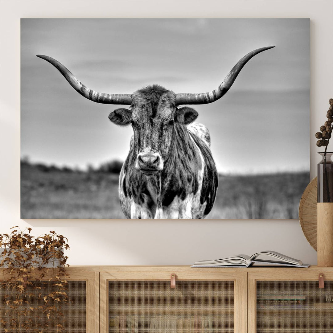 The Texas Longhorn Cow wall art, divided into three panels, is of gallery quality and displayed on a dark wall.