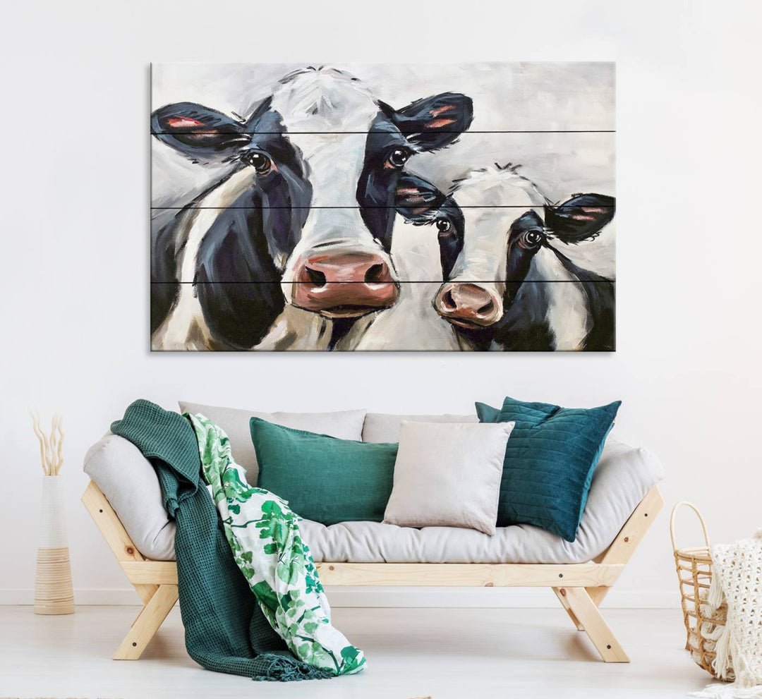 The Vintage Baby and Mom Cattle Canvas, featuring cows with black and white patches, is a prominent piece of wall art.