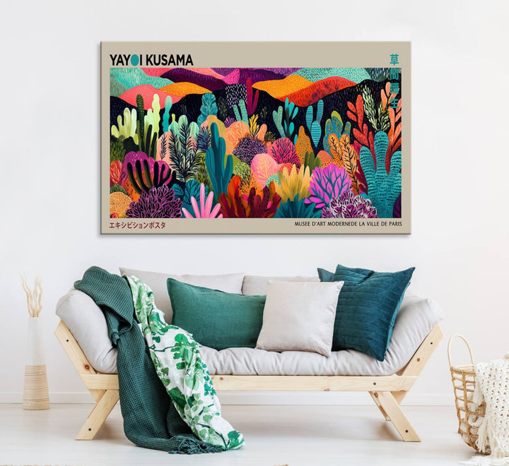 The framed Yayoi Kusama wall art adds vibrancy above the blue couch.