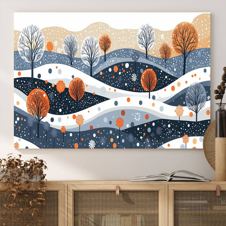 The "Abstract Winter Landscape Canvas Wall Art Print," featuring a triptych of landscapes with trees and hills in vibrant orange, white, and blue hues, adds a gallery-quality finish that transforms the space into an art lover's dream.