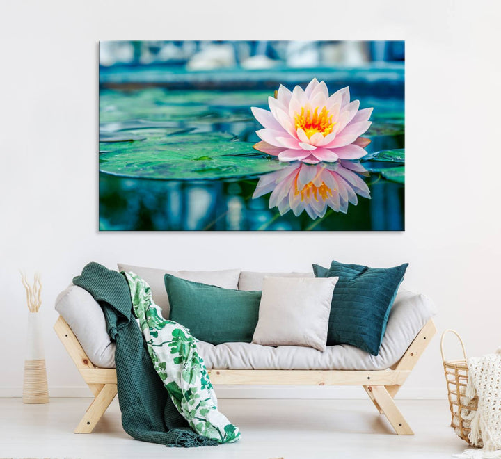 The Lotus Flower Canvas Print showcases a pink water lily with a yellow center gracefully floating on a calm pond.