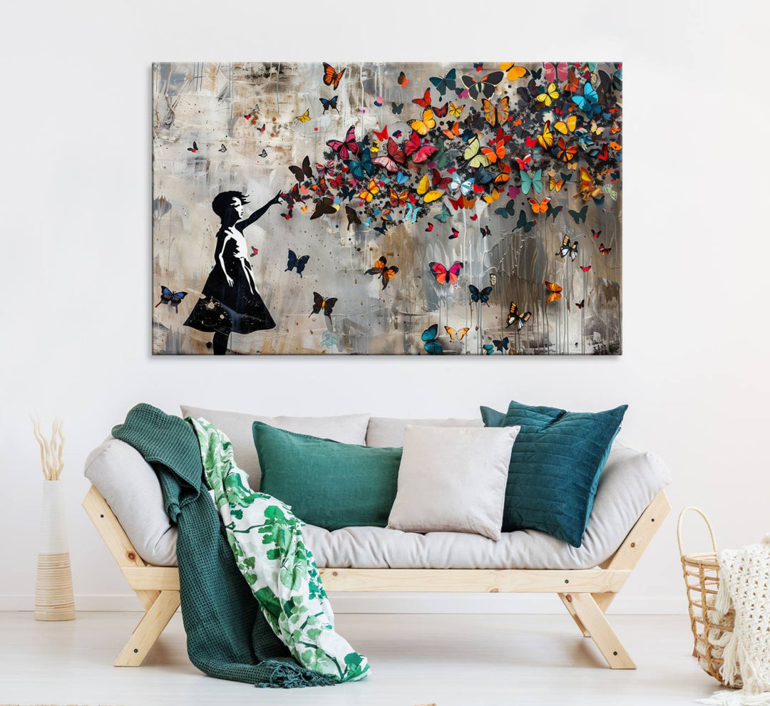 The Banksy Butterfly Girl 3-Piece Modern Graffiti Canvas Wall Art features a silhouette of a girl reaching for butterflies.