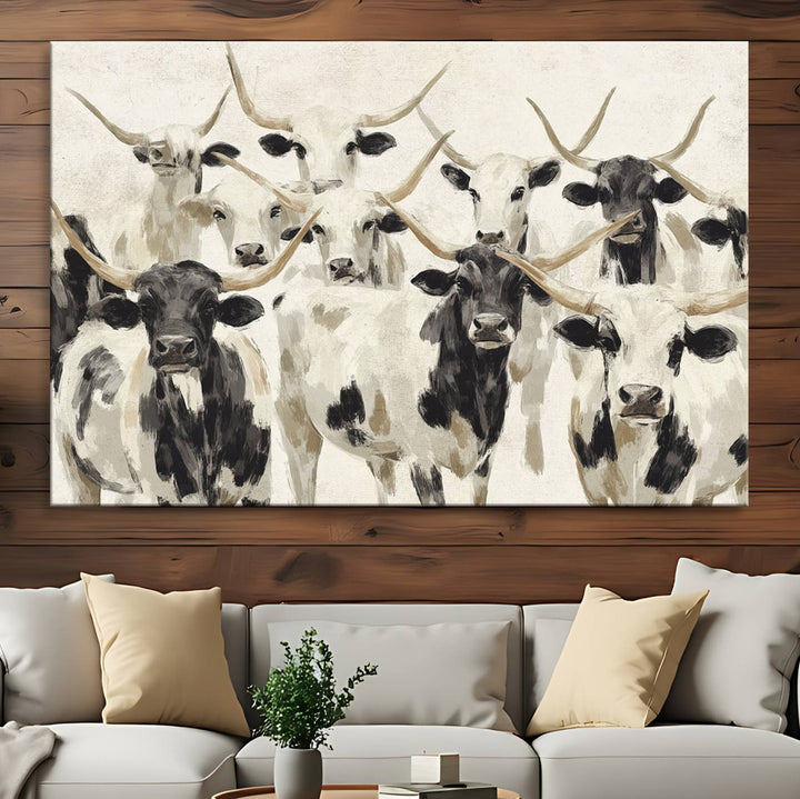 Canvas print titled Longhorn Texas Cow Drawing, depicting longhorn cattle with black and white markings, made in the USA, displayed on the wall.