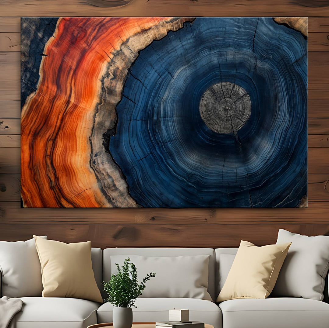 Abstract Tree Ring Wall Art Print on canvas featuring vibrant blue, orange, and brown rings with a natural rustic wood texture. Free shipping available!.