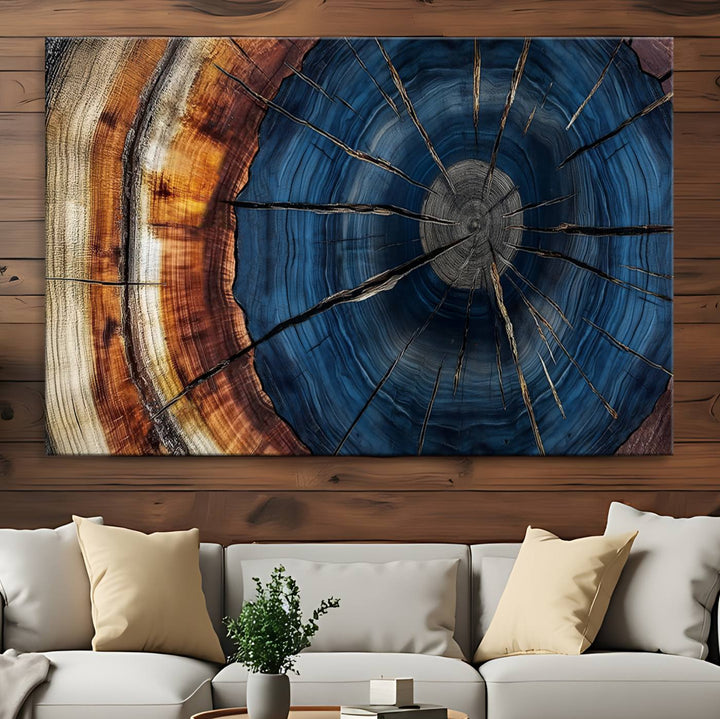 The Abstract Tree Rings Canvas Print features blue, brown, and orange rings that highlight wood grain and natures beauty.