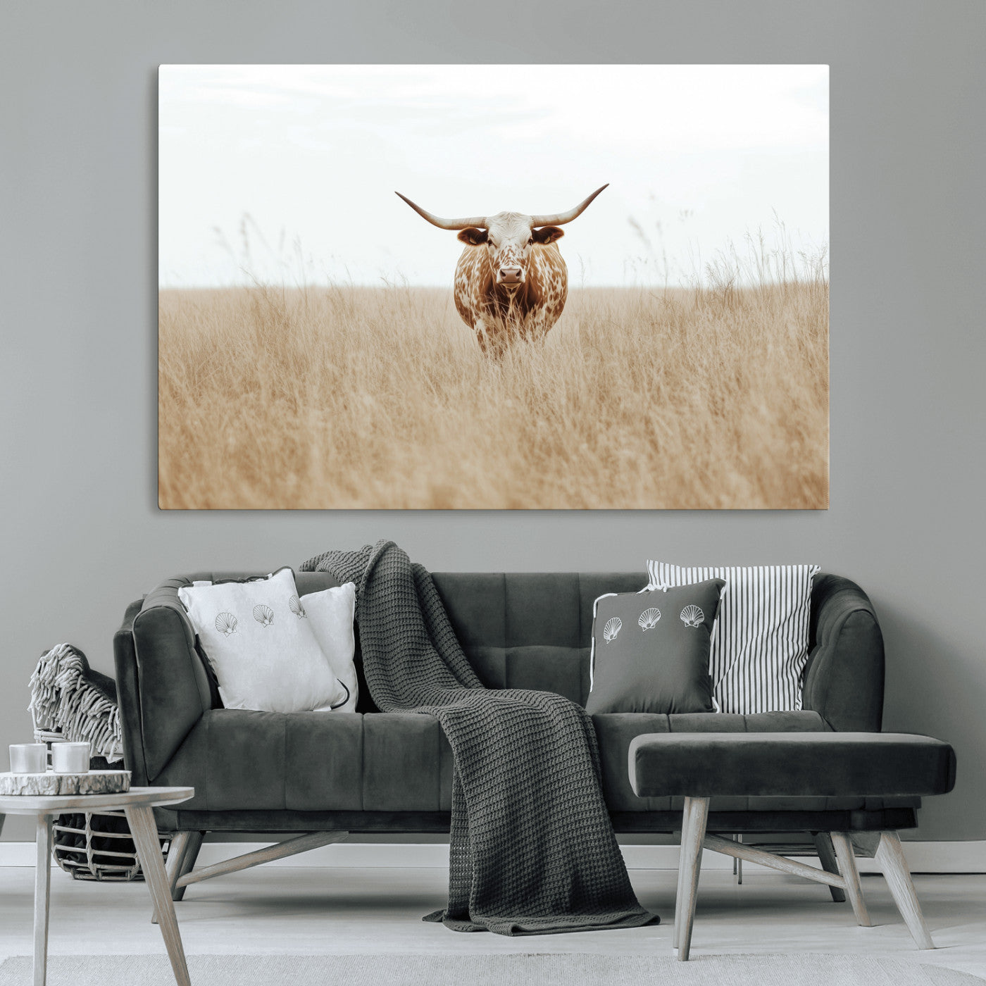 Texas Longhorn bull standing alone in dry grass with neutral tones, ideal for rustic western or cowboy-themed wall decor.