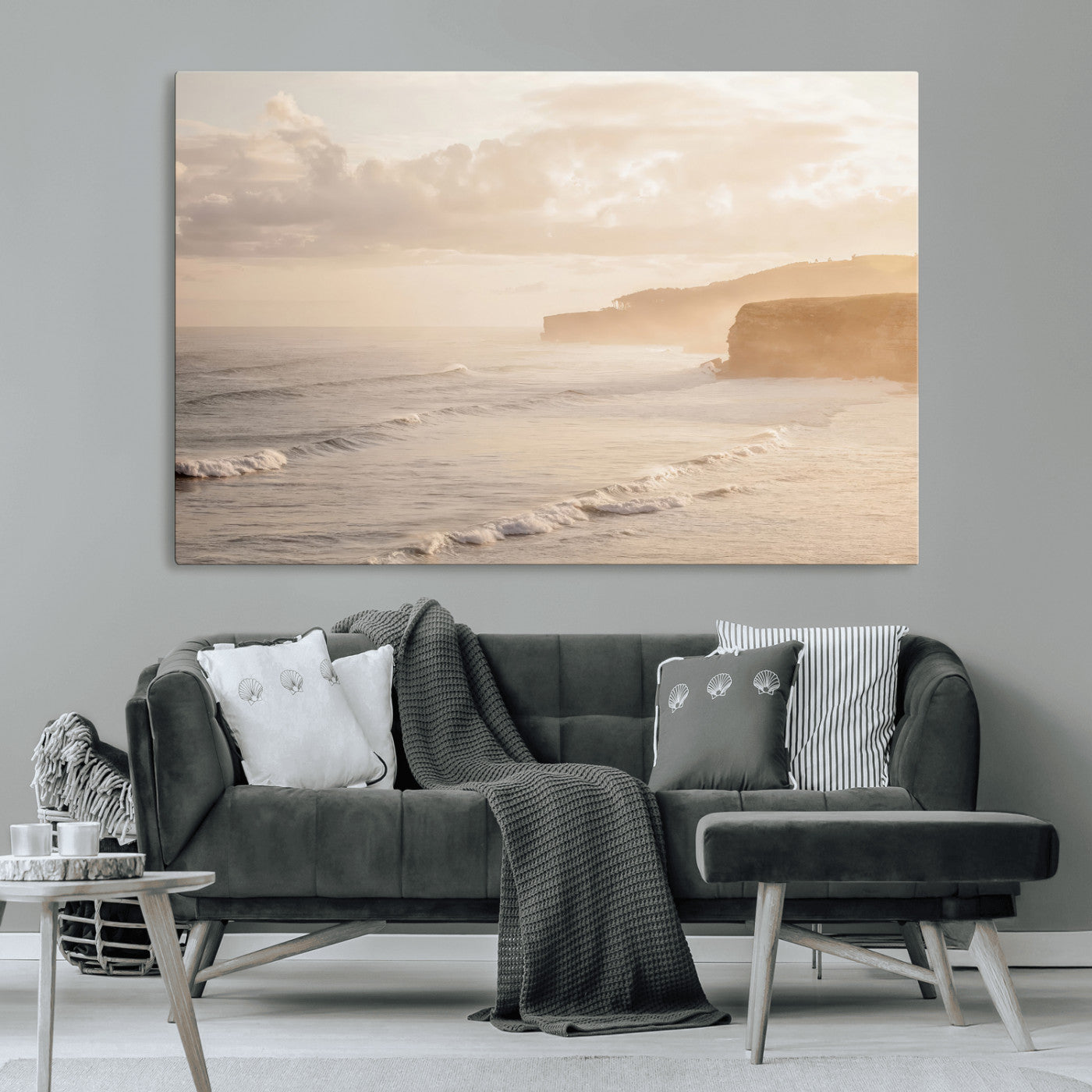 Golden hour seascape with misty cliffs and gentle waves rolling towards the shore, capturing a tranquil and warm coastal atmosphere.