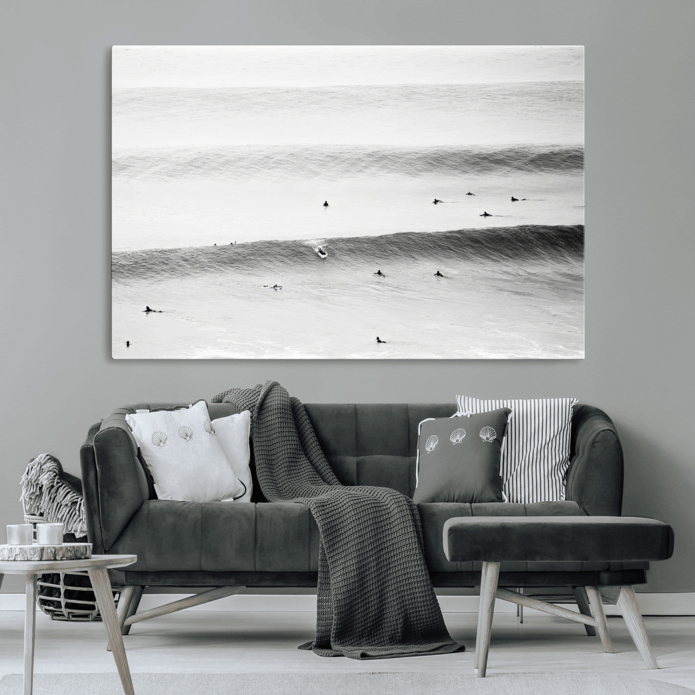 A monochrome photograph of swimmers gliding through gentle ocean waves, evoking a sense of calm and movement.
