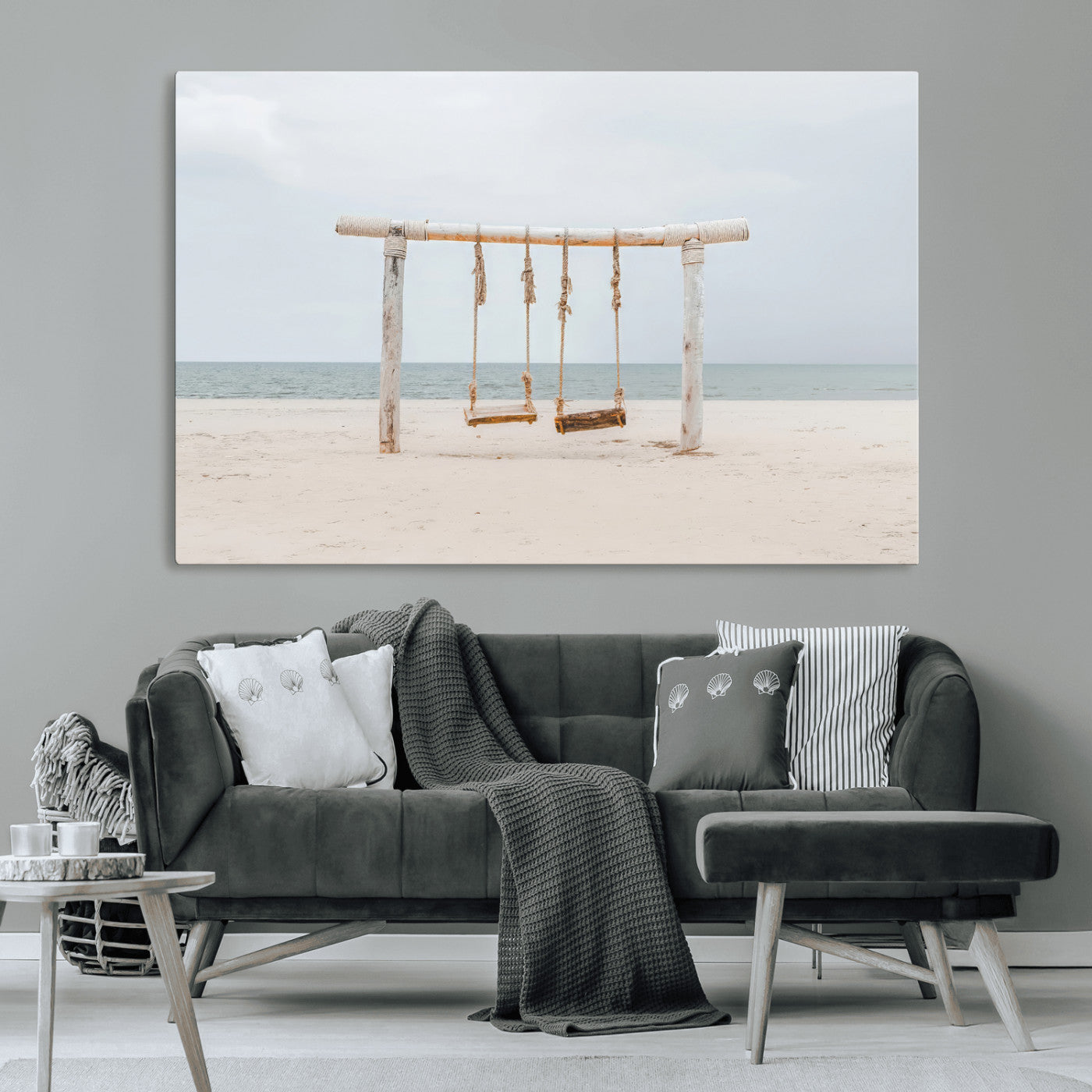 A rustic wooden beach swing stands on a serene sandy shore with an ocean horizon in the background, creating a tranquil and dreamy coastal escape.