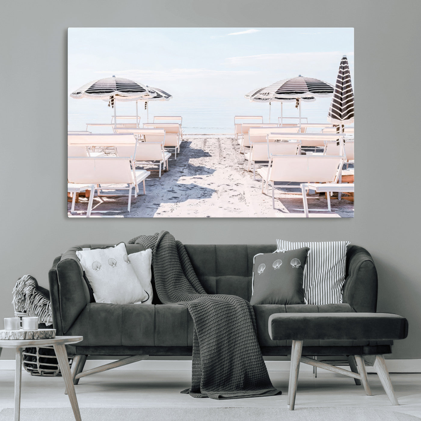 A serene minimalist beach scene featuring striped umbrellas, soft pastel sand, and an elegant lounge setup, creating a tranquil and stylish coastal retreat.