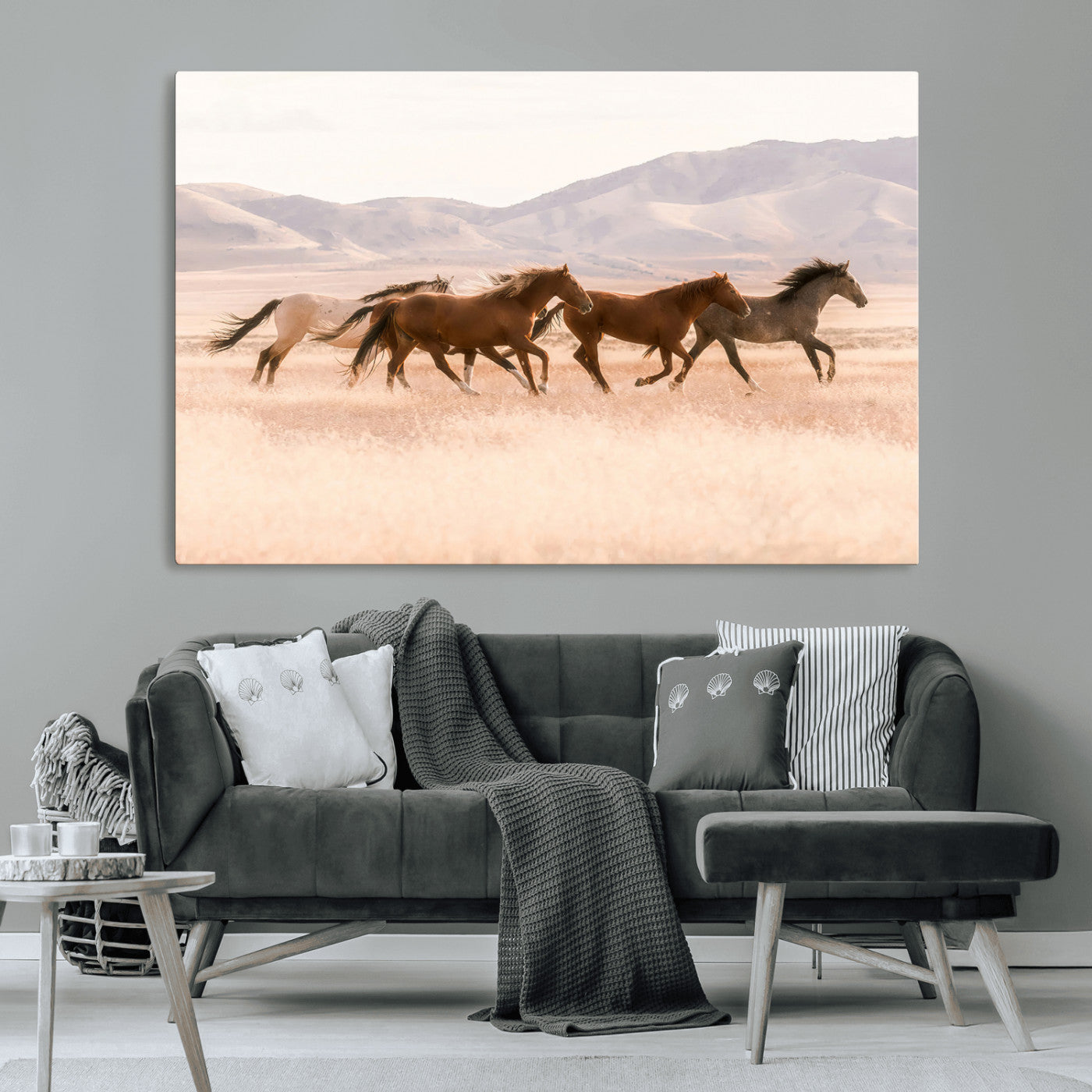 A herd of wild horses galloping through a sunlit desert plain with mountains in the background, perfect for rustic or western-themed wall decor.