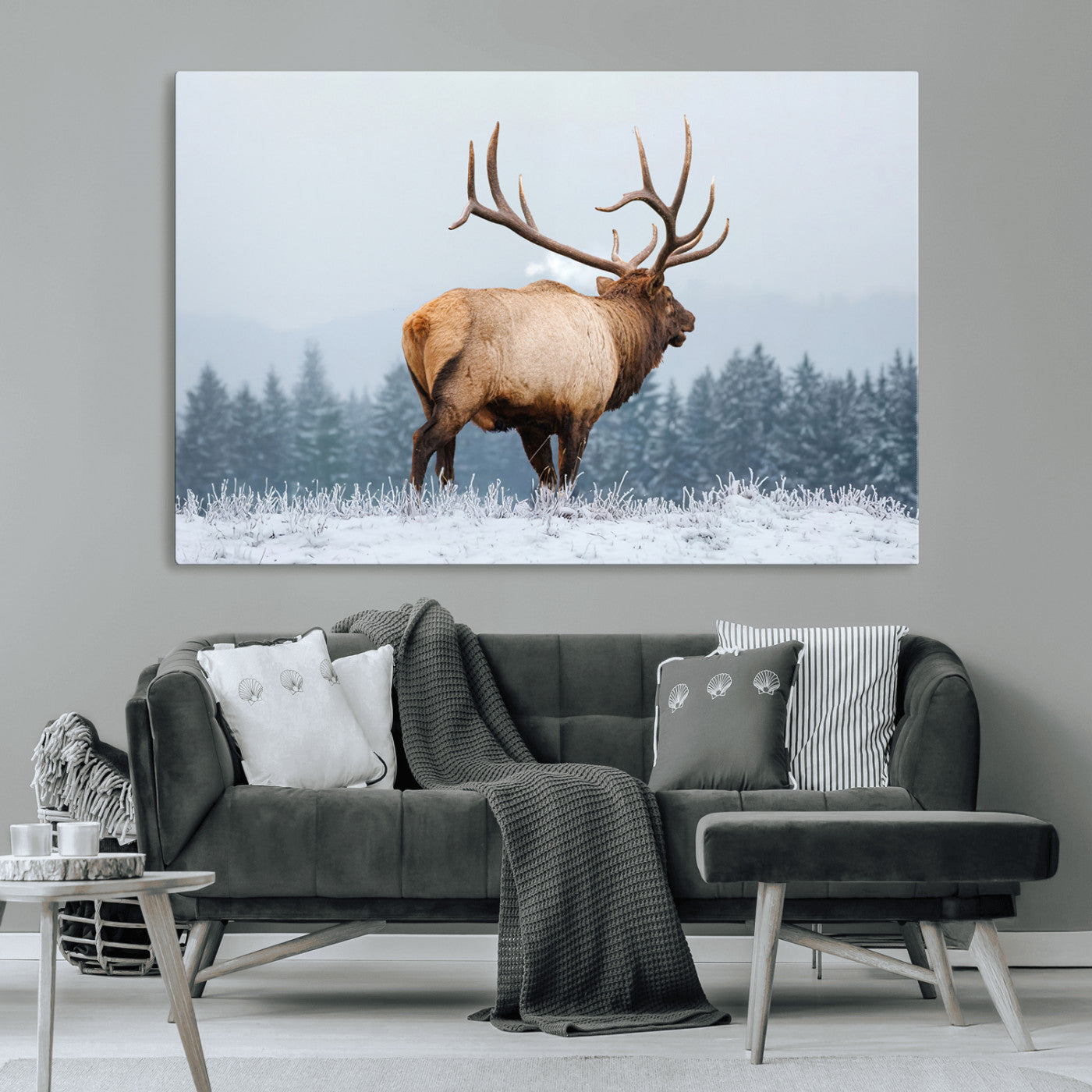 Large elk standing in a snowy field with pine trees in the background, ideal for rustic cabin or lodge-style wall decor.