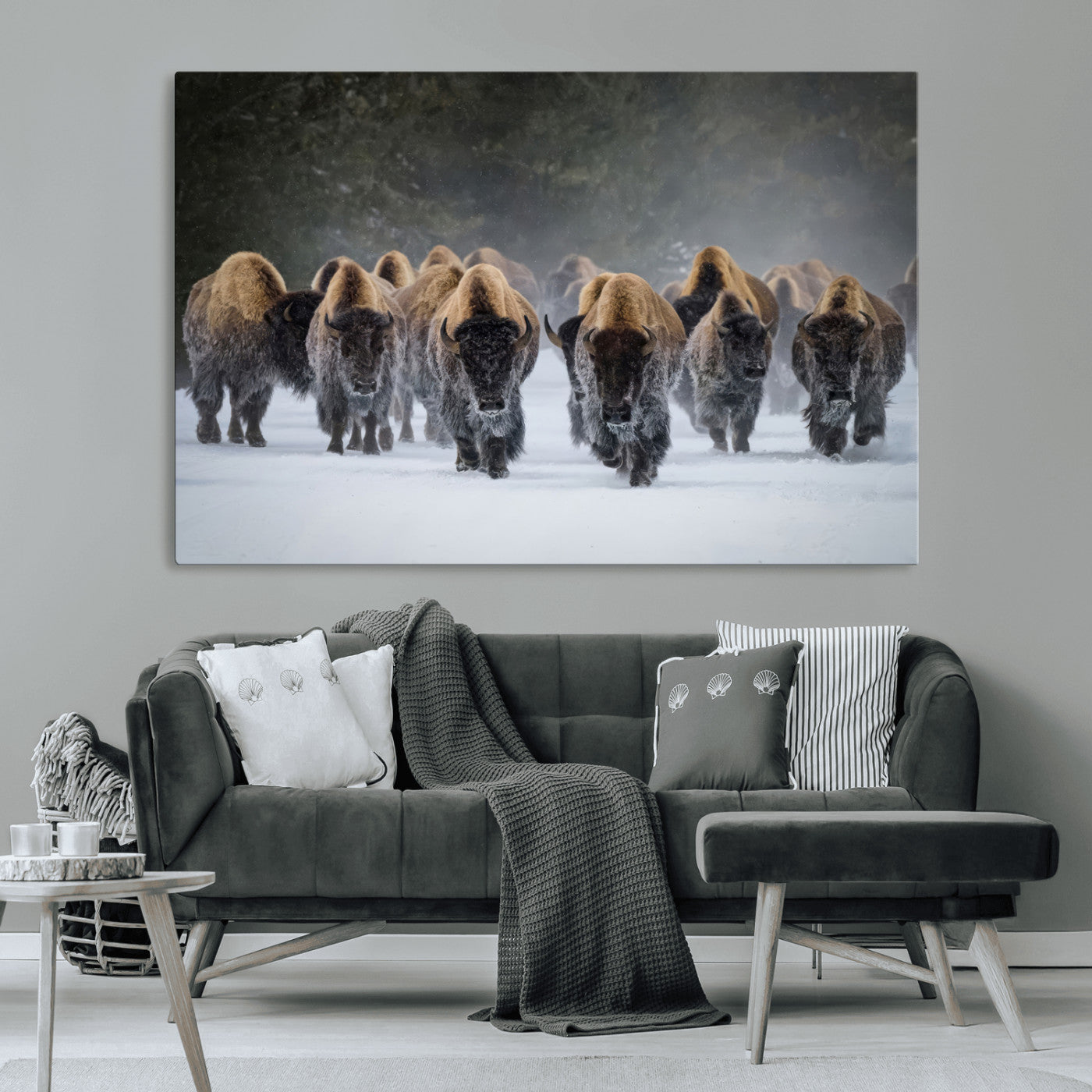 A herd of American bisons walking through deep snow in a forest, evoking a powerful rustic wilderness mood for western-style interiors.