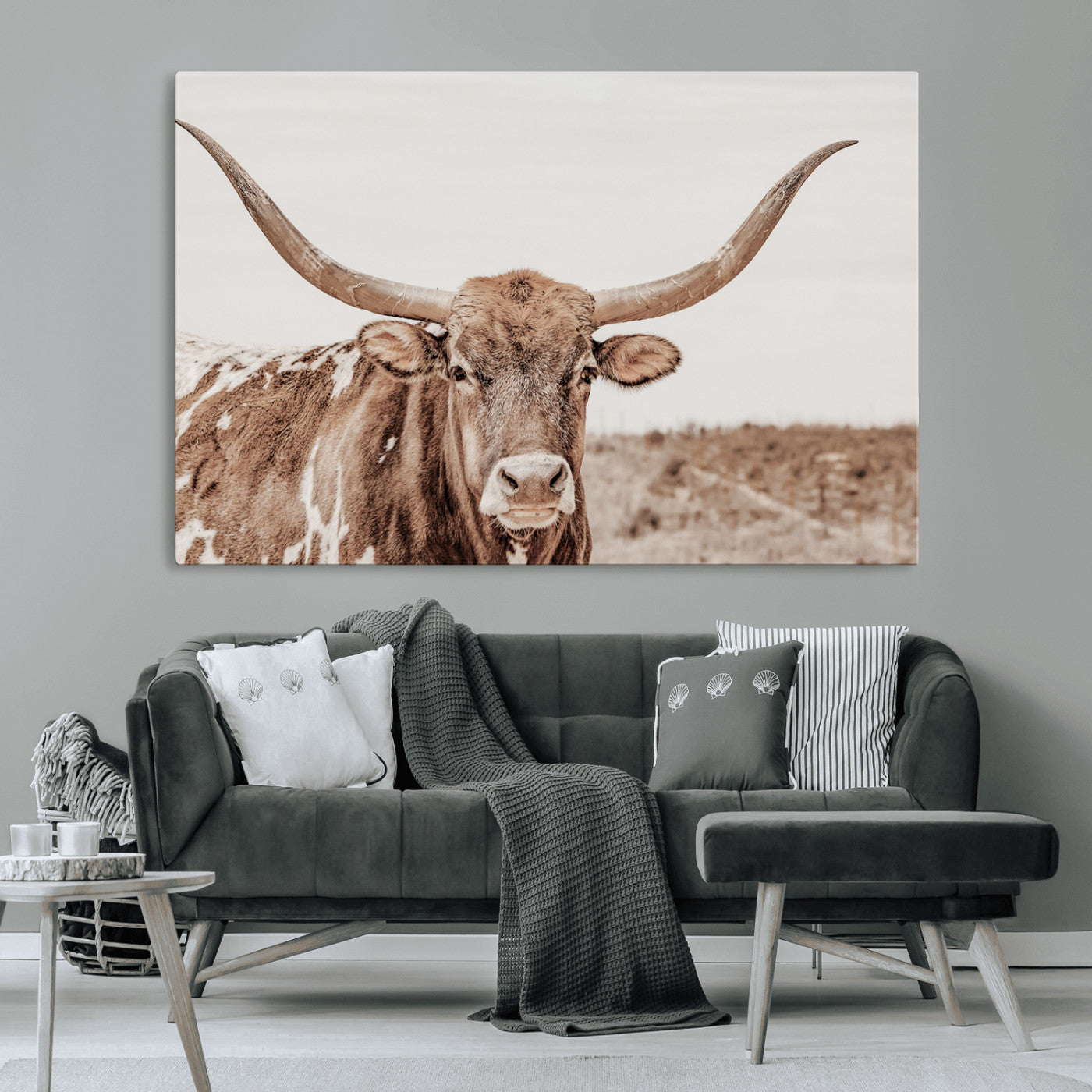 A longhorn cow in soft beige desert tones, standing calmly in open land, perfect for neutral western or rustic farmhouse interiors.