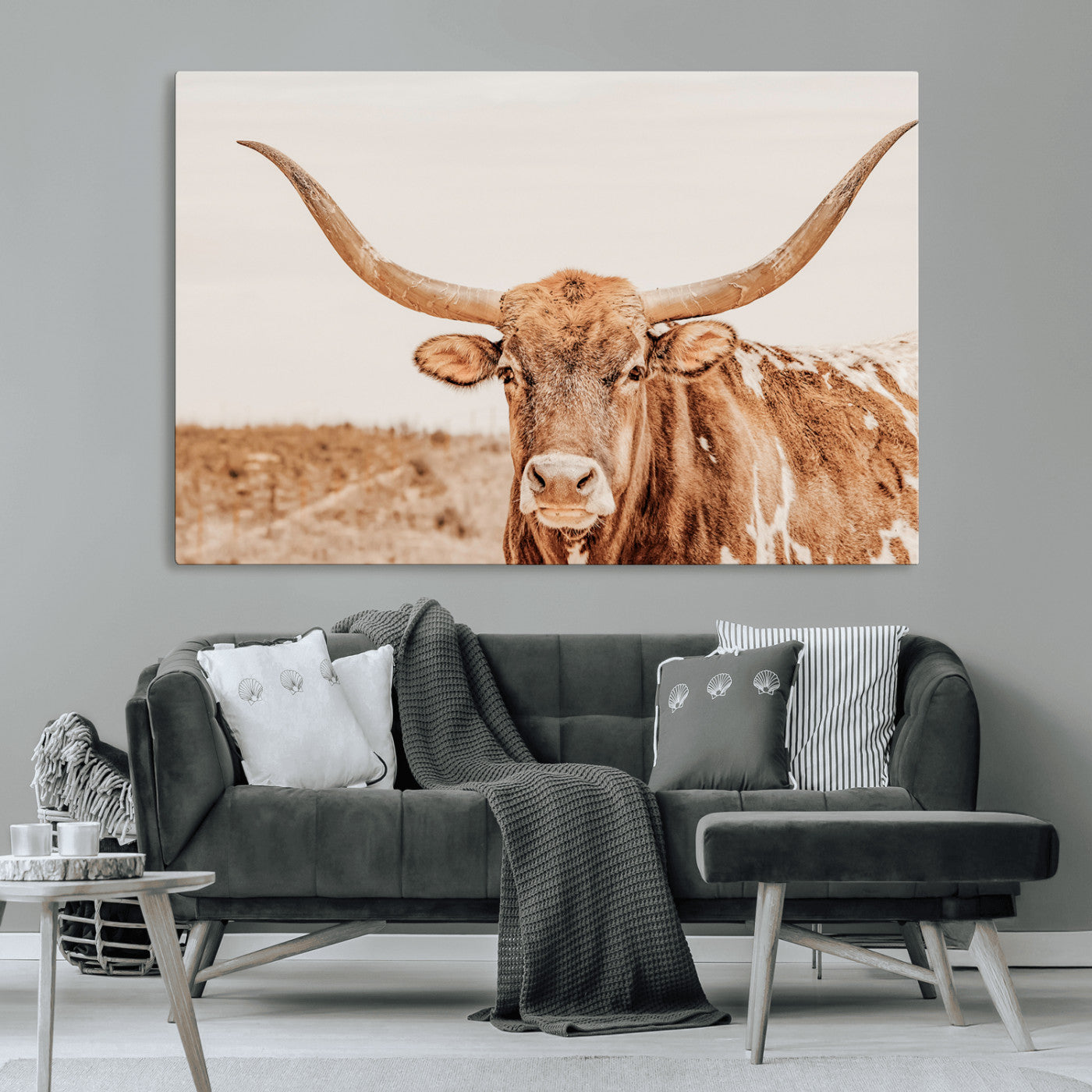 A longhorn bull standing proudly in a sunlit desert field with warm neutral tones, ideal for rustic western or farmhouse interiors.