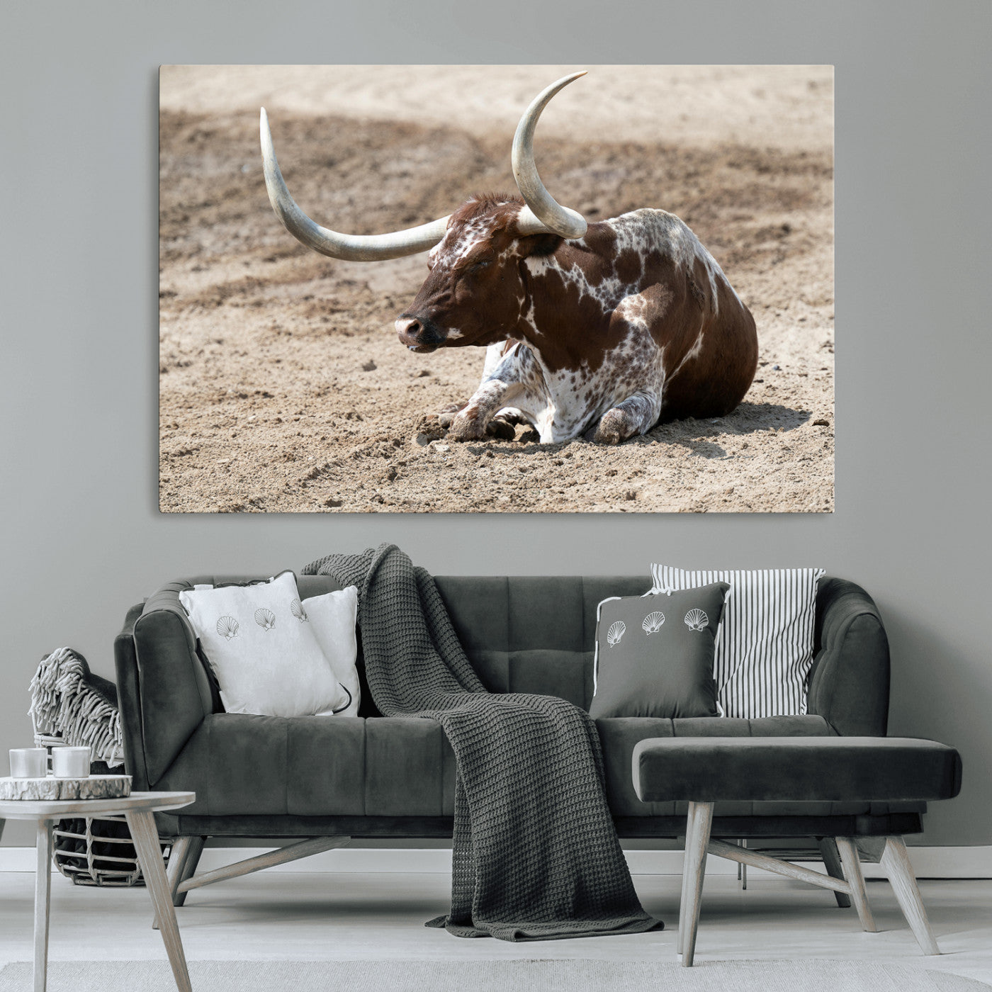 Texas Longhorn resting on sandy ground with large curved horns, capturing a rustic Western aesthetic perfect for farmhouse-style wall art.