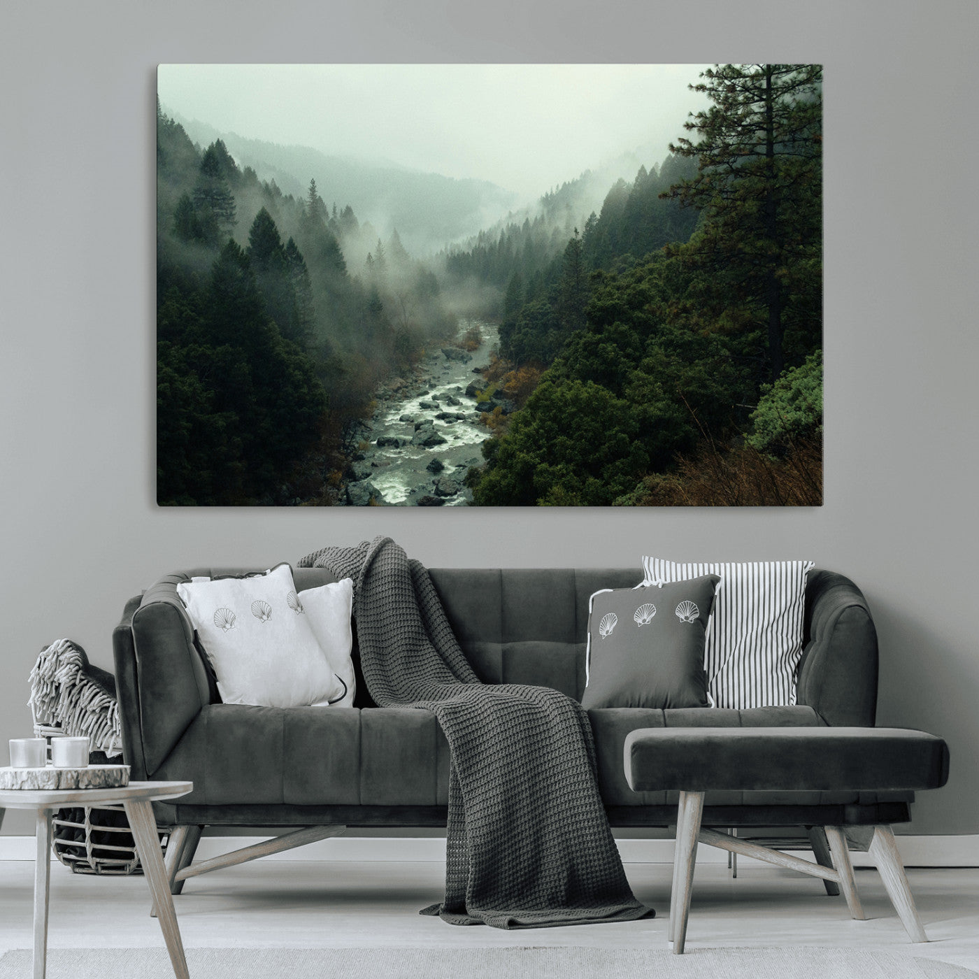 Misty forest with a winding river flowing through lush green mountains, creating a tranquil and moody wilderness landscape.