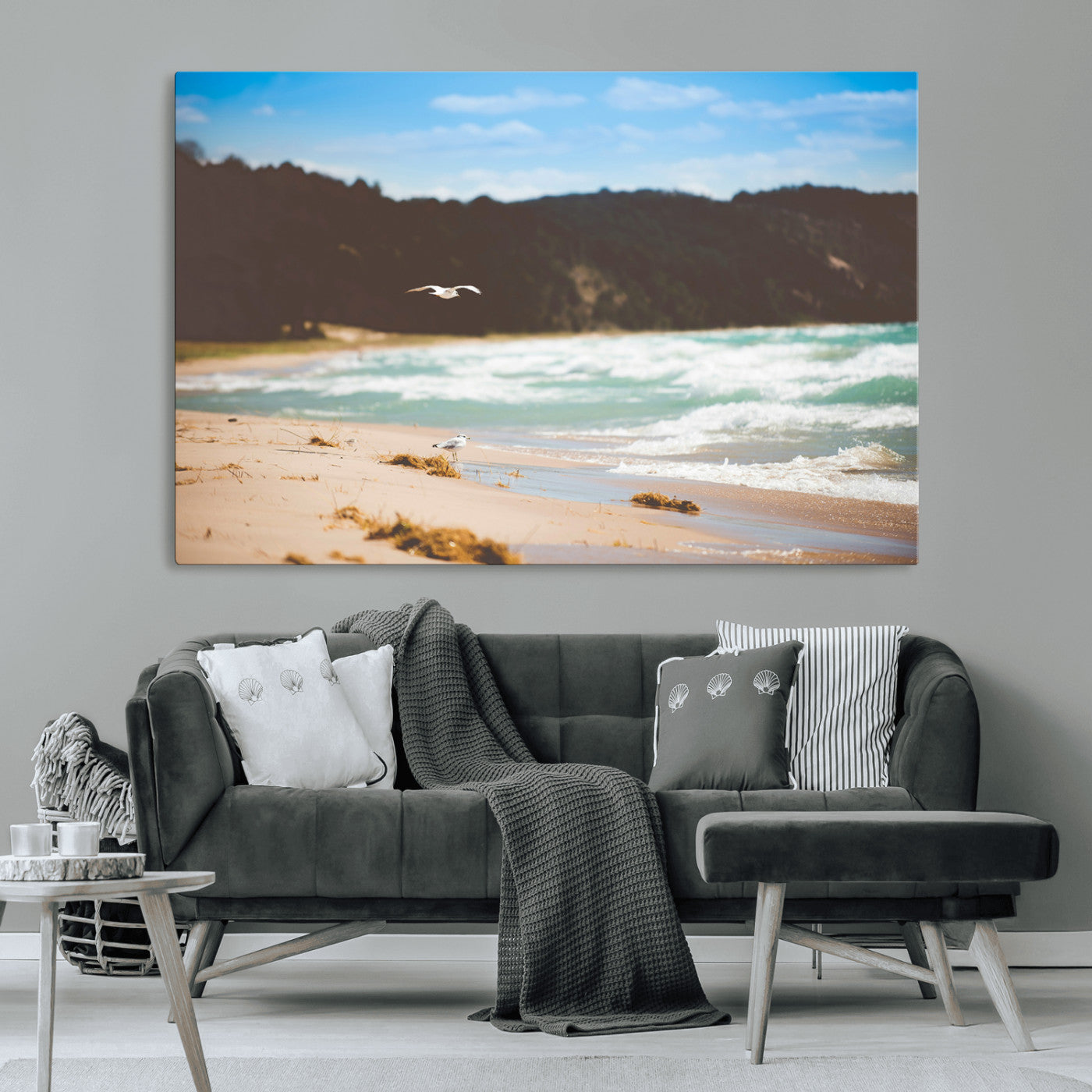 Serene beach scene with gentle ocean waves, sandy shore, and a seagull flying under a blue sky, perfect for coastal and nature-inspired decor.